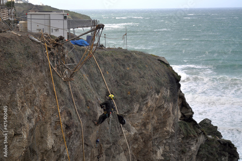 Принти на полотні Cliff hanger sea defence structure strengthening in gale force weather Newquay C