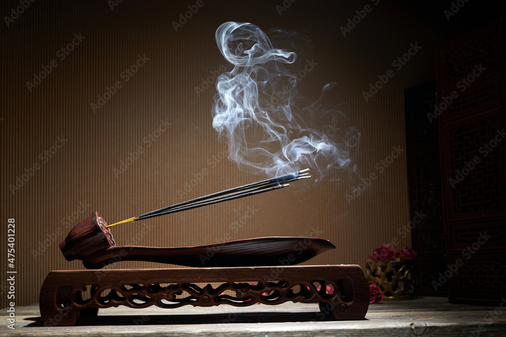 Smoke from burning incense sticks standing on lotus incense holder foto de  Stock | Adobe Stock