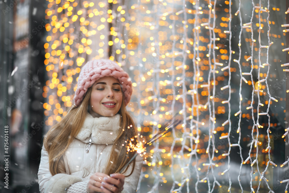 Lovely lady playing with sparklers at the decorated showcase Lovely lady playing with sparklers at the decorated showcase