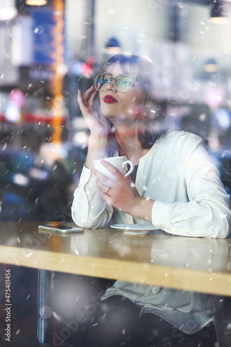 Charming lady keeps warm with a cup of hot coffee