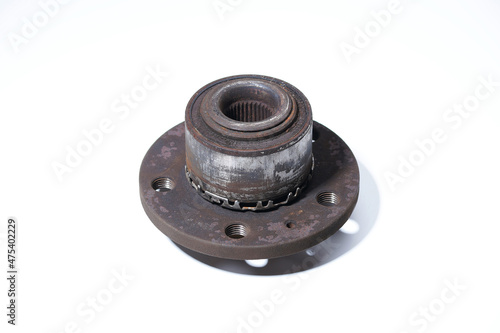 Wheel hub on a white background. Used wheel bearing is dirty. Brake disc holes for caliper studs.