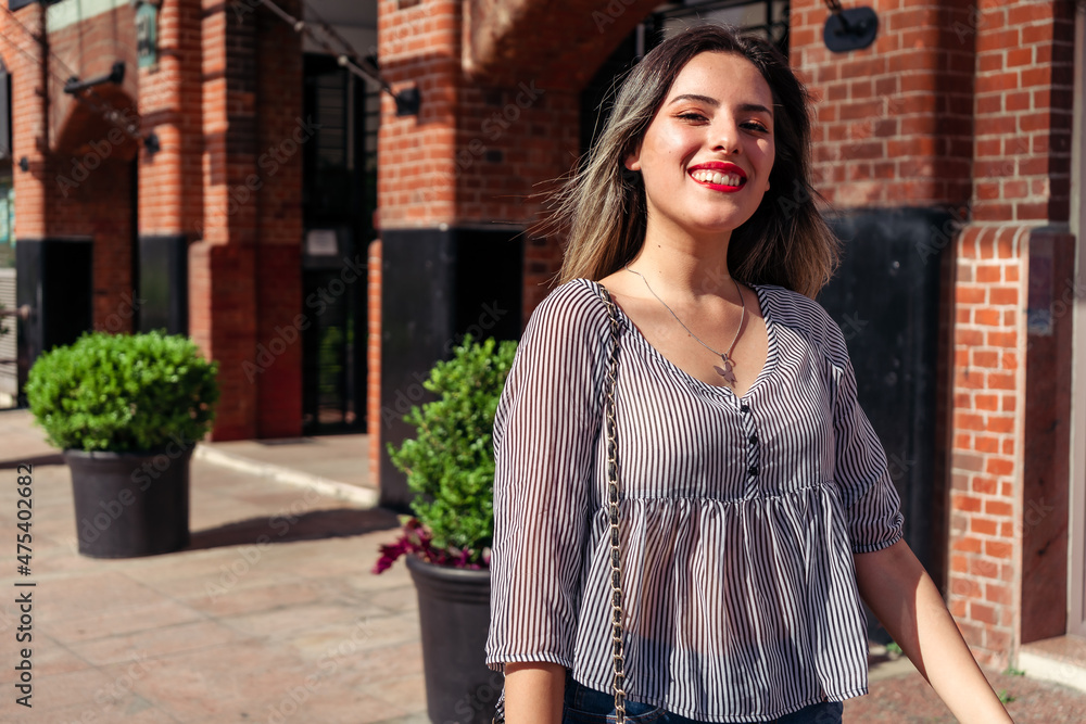 Portrait of a smiling latin woman in the street on a sunny day Portrait of a smiling latin woman in the street on a sunny day