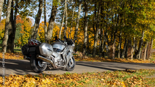 Yamaha FJR grey motorcycle on road in autumn. Rear view of the motorcycle. Banner of beautiful Yamaha motorcycle on road in autumn. Many trees with bright foliage. Minsk Belarus, September 01, 2021