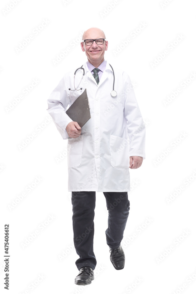 in full growth. senior doctor with clipboard striding forward. in full growth. senior doctor with clipboard striding forward.