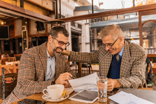 Writing the plans while laughing and sitting