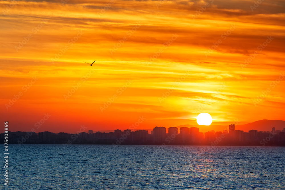 Naklejka premium Sunset landscape of Mersin coast. Mersin is the provincial capital of the eponymous Mersin Province of Turkey. It has a hot-summer Mediterranean climate a type of subtropical climate with hot.