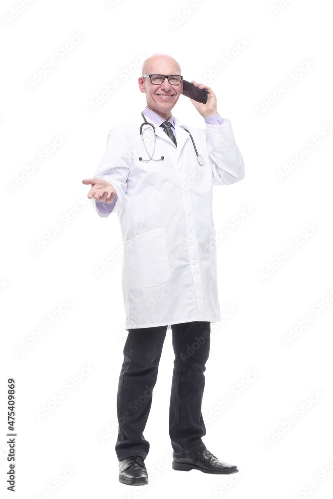 in full growth. smiling doctor with a smartphone. in full growth. smiling doctor with a smartphone.