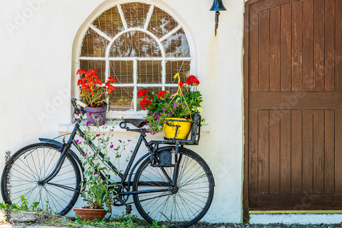 Europe, Ireland, County Cork. Bicycle next to house with potted plants.