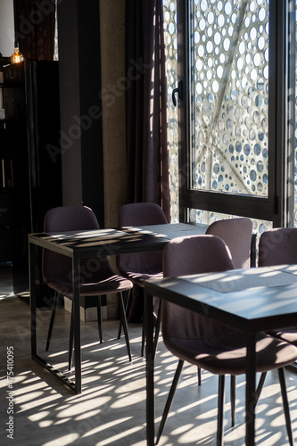The interior of a cozy cafe. Beautiful shadows on the floor and on the table. 