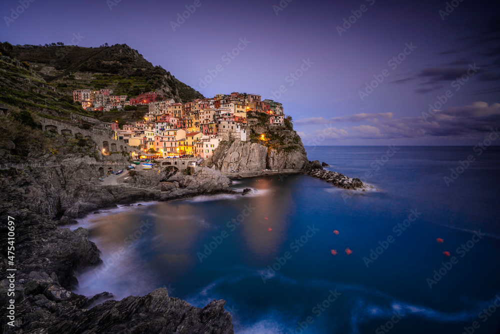 Europe, Italy, Manarola. Sunset coastline with town and ocean.