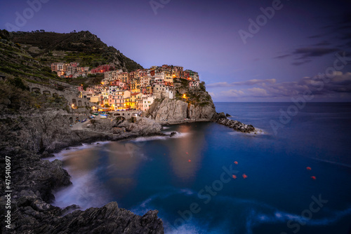 Europe, Italy, Manarola. Sunset coastline with town and ocean.
