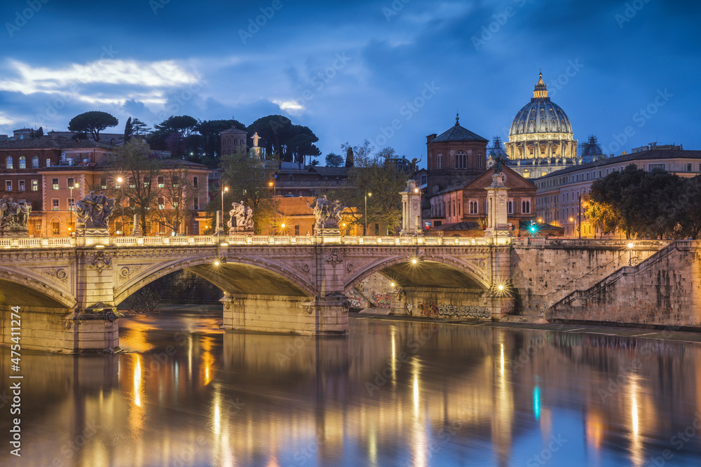 Europe, Italy, Rome. Dome of Sistine Chapel with Tiber River and bridge lit at sunset.