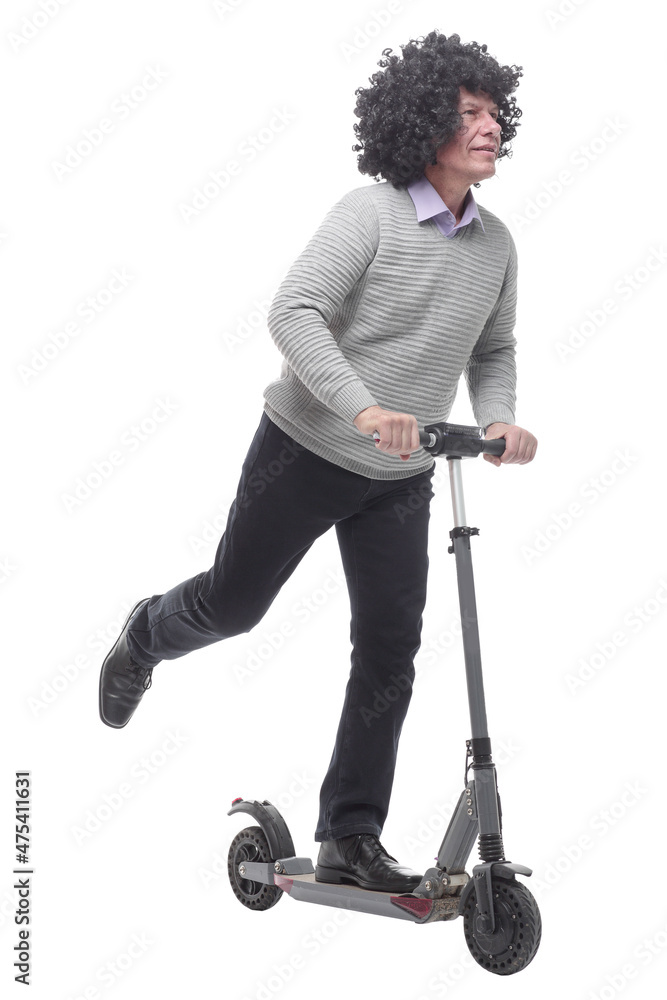 in full growth. cheerful man with an electric scooter. in full growth. cheerful man with an electric scooter.