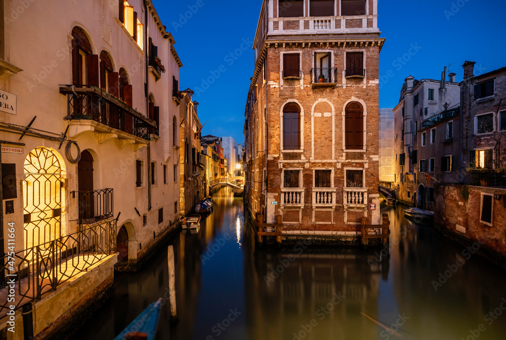 Europe, Italy, Venice. Two converging canals and buildings at sunset.