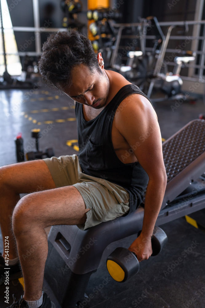 Obraz premium Man doing chest workout, bench press with dumbbells