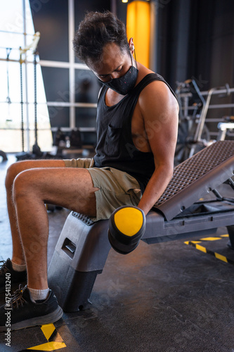 Man doing Biceps curl in the gym