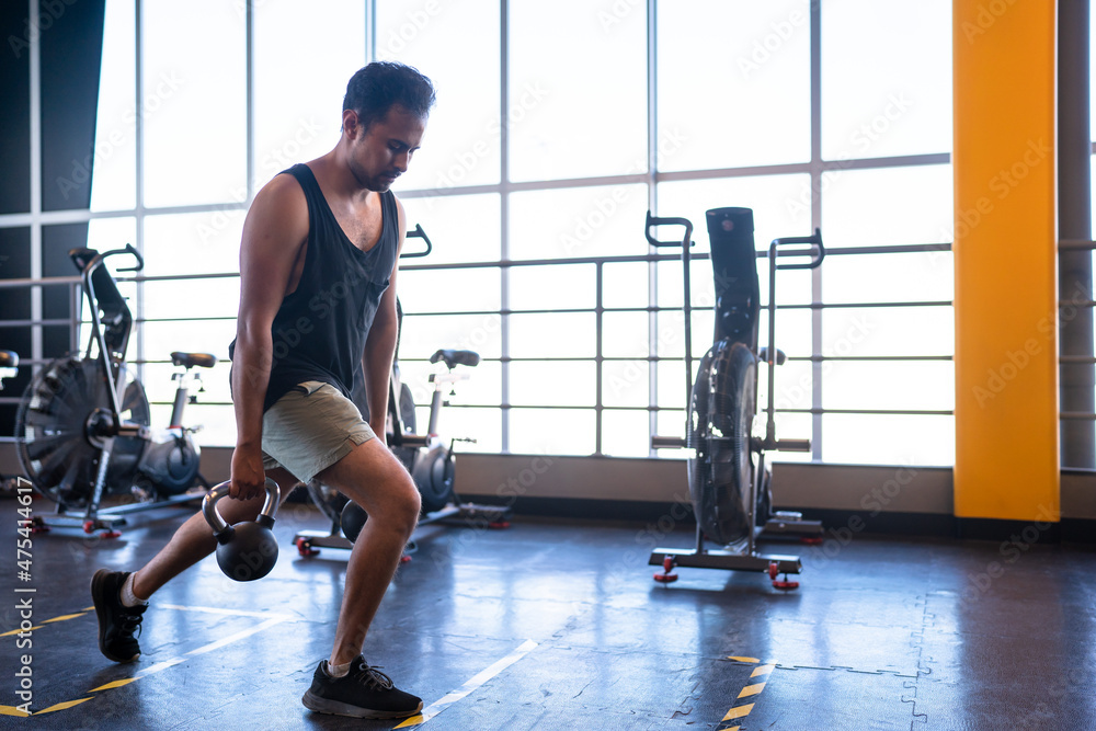 Fototapeta premium person doing lunges in a gym