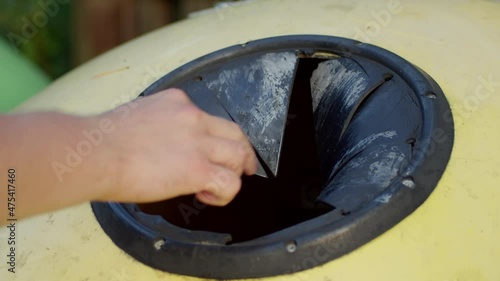 Recycling plastic bottles by disposing them into special container.