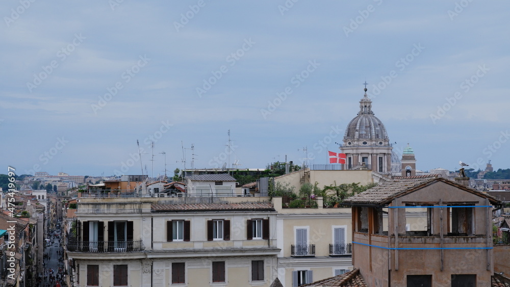 A view across the rooftops of Rome at sunset on a winter day.