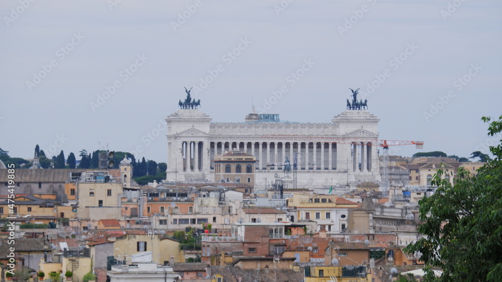 Statues And Italian Flags At Altare Della Patria Against Clear Sky 