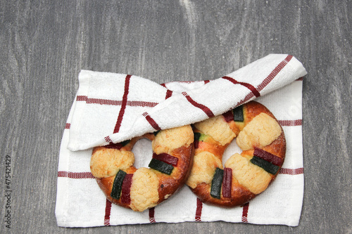 The roscón, rosca de Reyes or king cake is a sweet dough bun decorated with candied or crystallized fruit, with figurines inside for January 6, Three Kings Day.
