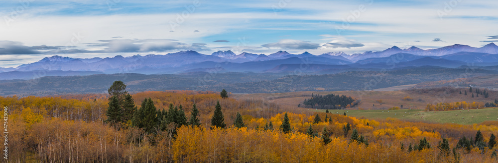 Canadian Rocky Mountain range landscape and panoramic autumn color background. Alberta prairie valley scenery and mountain lookout background. Beautiful panorama of the fall forest and mountains