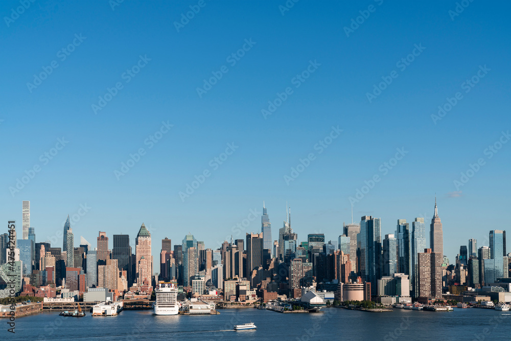 Fototapeta premium New York City skyline from New Jersey over the Hudson River with the skyscrapers of the Hudson Yards district at day time. Manhattan, Midtown, NYC, USA. A vibrant business neighborhood