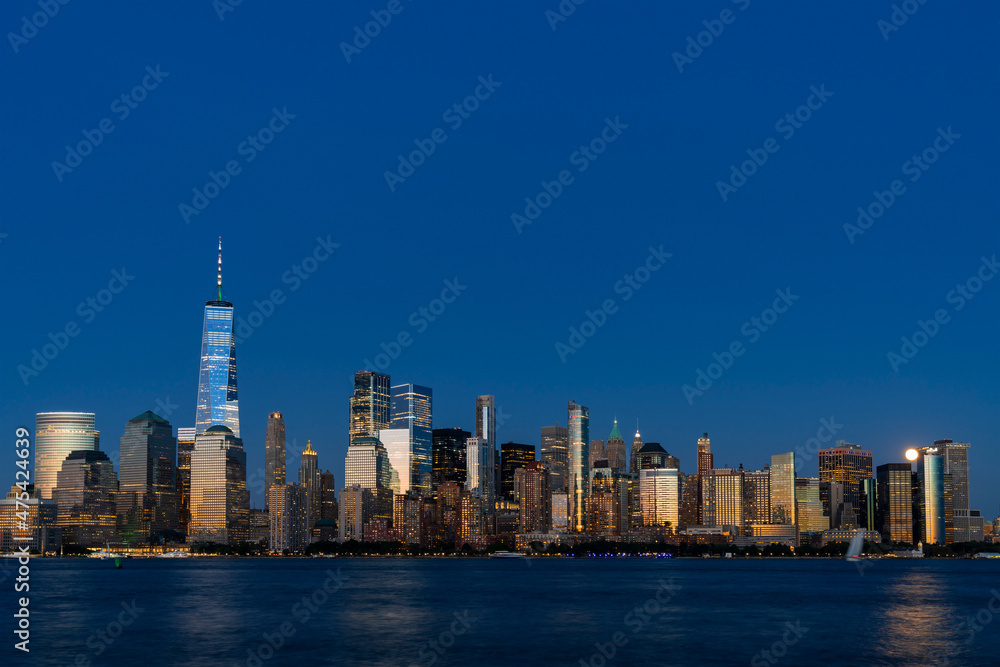 Obraz premium Skyline of New York City Financial Downtown Skyscrapers at night. Manhattan, NYC, USA. A vibrant business neighborhood