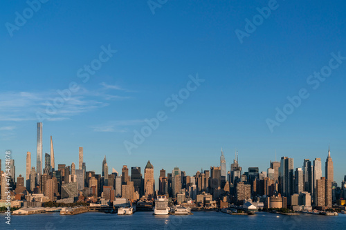 Aerial New York City skyline from New Jersey over the Hudson River with the skyscrapers of the Hudson Yards district at sunset. Manhattan, Midtown, NYC, USA. A vibrant business neighborhood