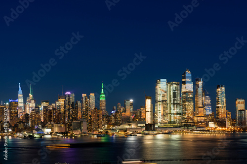 Aerial New York City skyline from New Jersey over the Hudson River with the skyscrapers of the Hudson Yards district at night. Manhattan  Midtown  NYC  USA. A vibrant business neighborhood