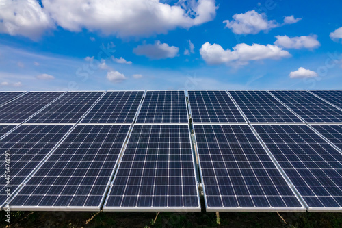 Solar power plant, solar panel, blue sky and clouds