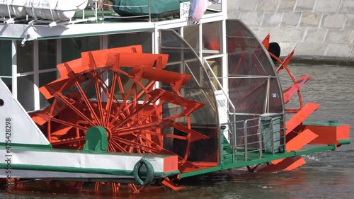 Red Riverboat Paddle Wheel in a River with Treeson