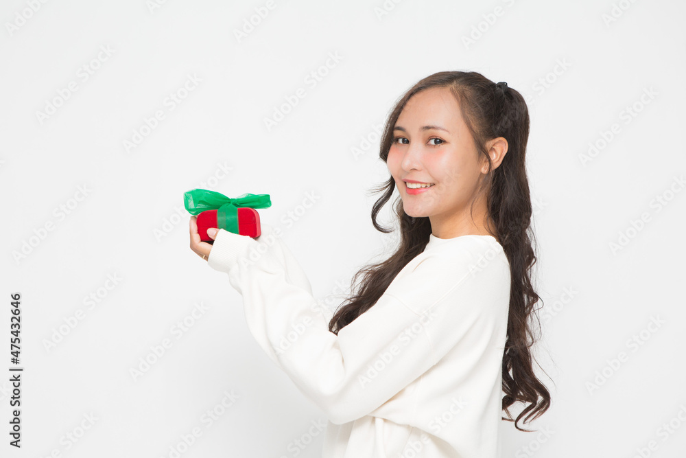 Beautiful Asian woman wearing white sweater holding red gift box on white background. Beautiful Asian woman wearing white sweater holding red gift box on white background.