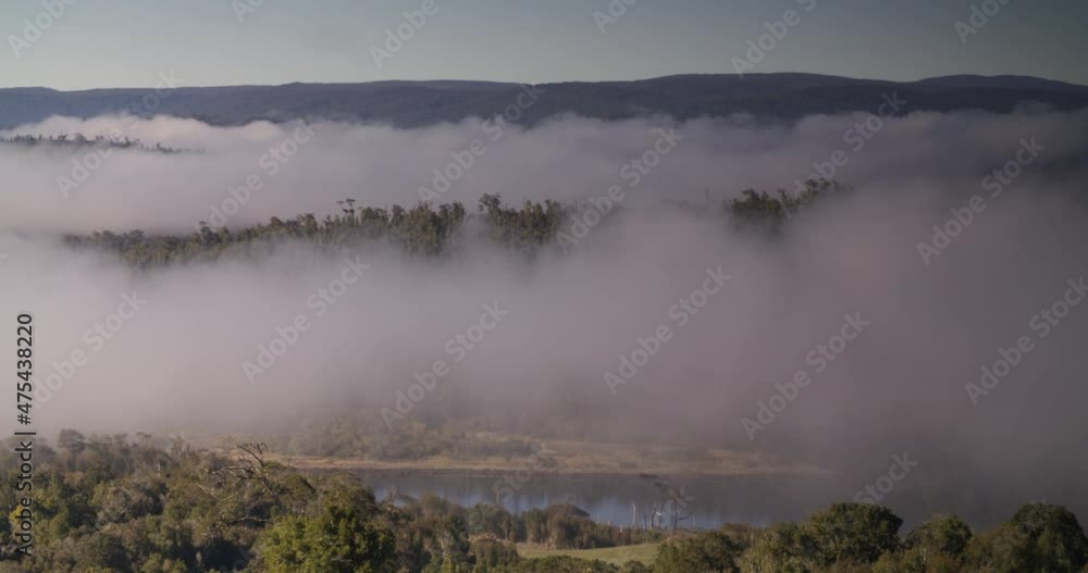 coastal mountain range at sunrise covered by morning mist clouds coastal mountain range at sunrise covered by morning mist clouds