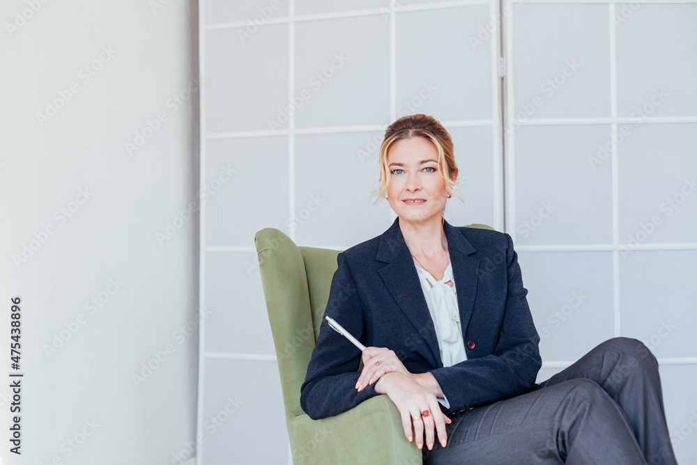 female psychologist in the office in a green chair for consultation female psychologist in the office in a green chair for consultation