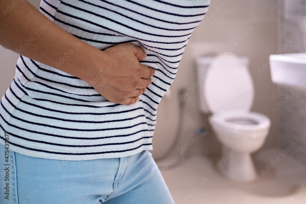 women-are-standing-in-front-of-the-bathroom-door-using-their-hands-to