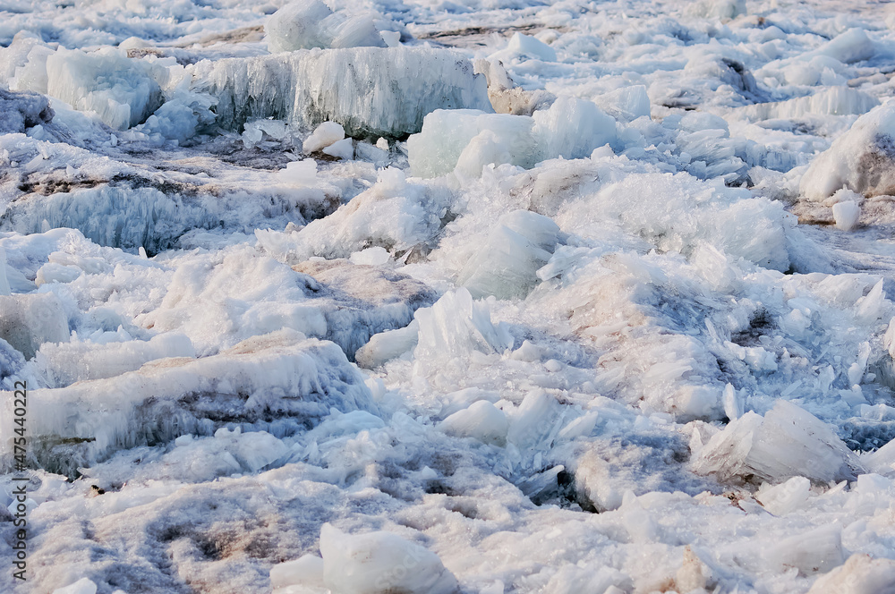Ice structure of river hummocks in spring. Sharp ice needles on the banks of the Amur River. Selective focus. Blagoveshchensk, Russia. Ice structure of river hummocks in spring. Sharp ice needles on the banks of the Amur River. Selective focus. Blagoveshchensk, Russia.