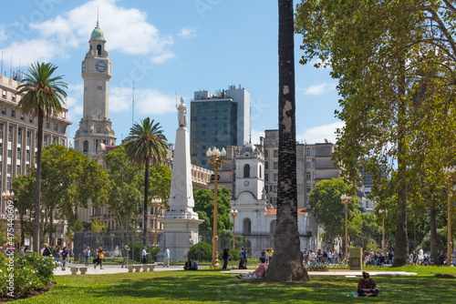 Clock tower of City Legislature Building, May Pyramid and Buenos Aires Cabildo in Plaza de Mayo, Buenos Aires, Argentina