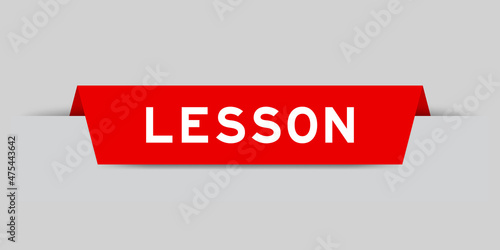 Red color inserted label with word lesson on gray background