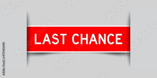 Inserted red color label sticker with word last chance on gray background