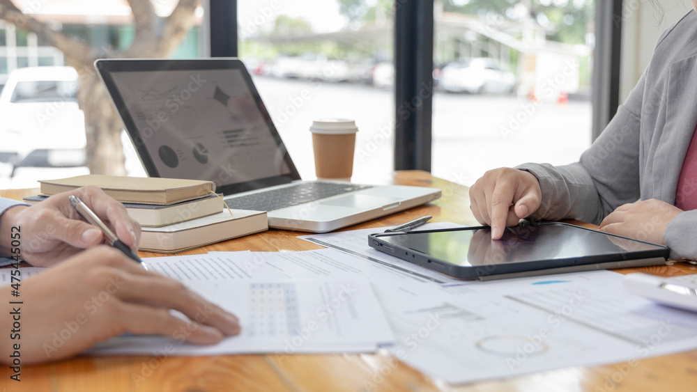 Fototapeta premium Brainstorm team, Marketers and financial accountants are discussing and analyzing charts to plan strategies to meet customer needs, Using graphs and tablet to analyze business data, Meeting concept.