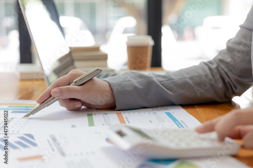 Canvastavla Asian businesswomen are analyzing graphs, Financial statistics and calculating corporate returns in private offices, Market research reports and income statistics, Financial and Accounting concept