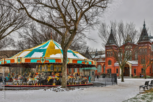 USA, District of Columbia. Carousel in Front of the Smithsonian Castle on a snowy afternoon. photo