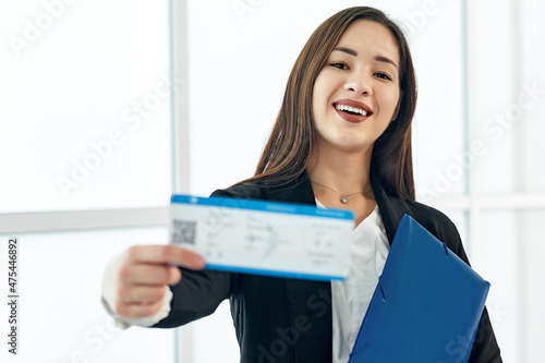 Asian Business woman with tickets waiting for departure in airport