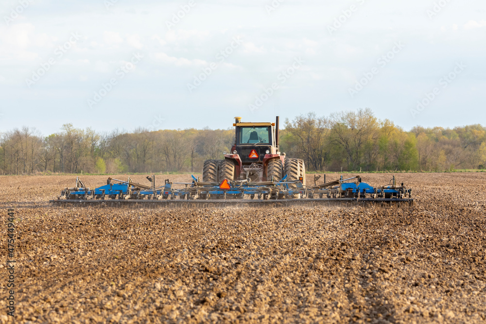 Tractor working the soil before planting, Marion County, Illinois Tractor working the soil before planting, Marion County, Illinois