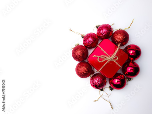 Christmas red ball and gifts box on a white background. Holidays christmas background. Copy space for text or design. View from above.