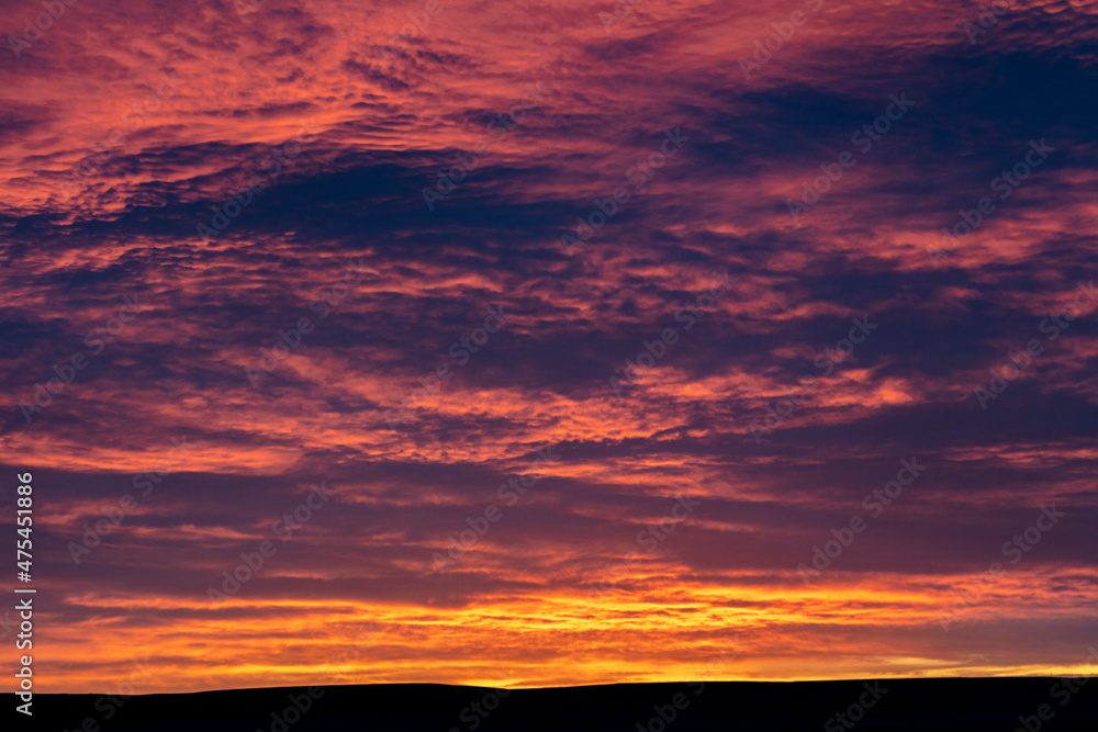 Sunrise skies from Freezeout Lake Wildlife Management Area looking to prairie near Choteau, Montana, USA