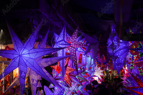 Photography Christmas lights lightning paper lantern star hanging in Christmas market in Kerala India lots of bright colorful stars night photo
