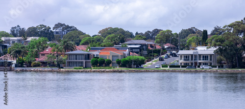 Panorama view of Concord Bay on Sydney Harbour NSW Australia, wealthy houses on the forshore nestled between lush green trees