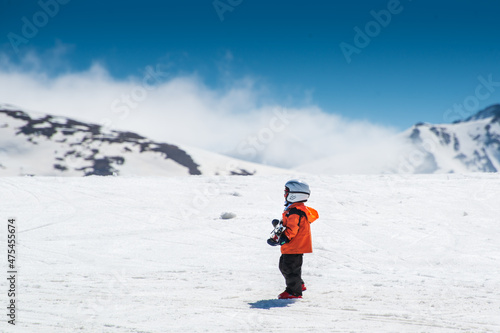Little boy wainting her mother in a ski resort photo